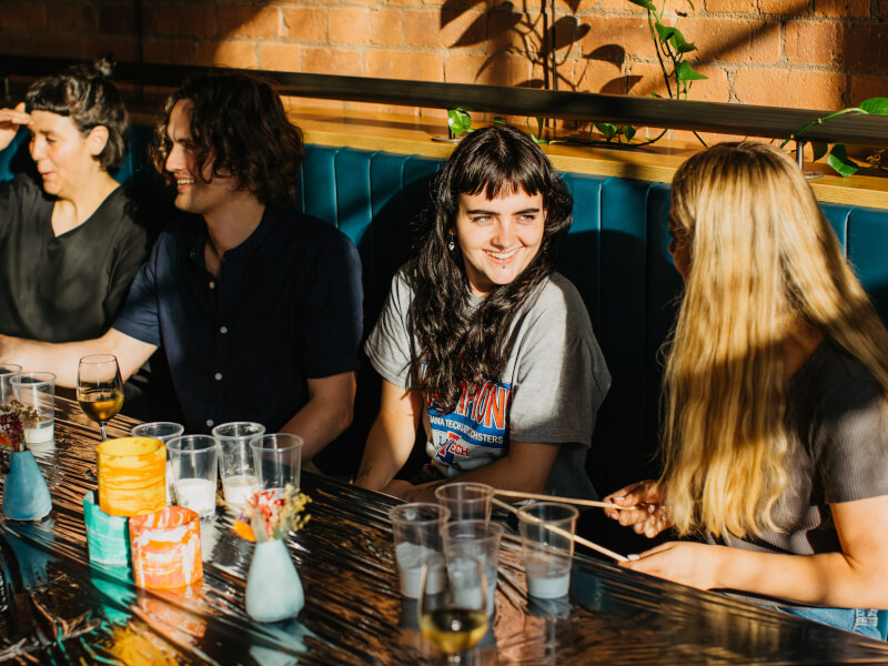 Group of young people at an art workshop with smiling girl in focus